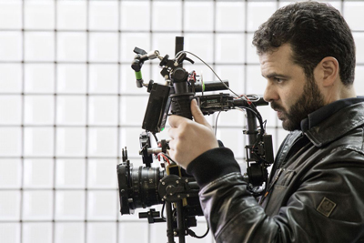 Edoardo De Angelis holding a video camera